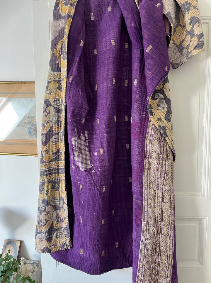 Détail des broderies artisanales et des traces d'usures sur un couvre-lit Kantha vintage en coton
