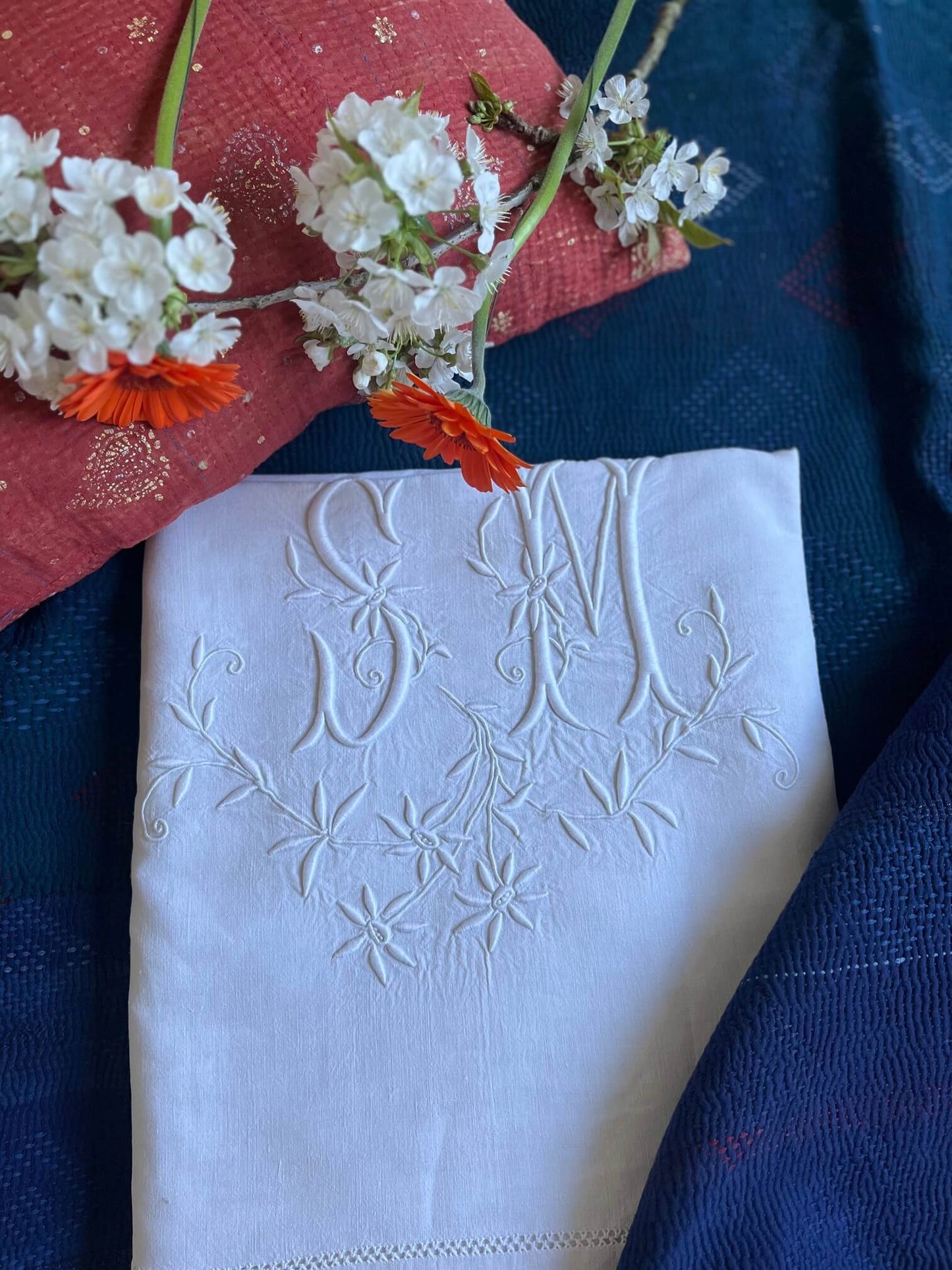 Drap ancien brodé SM, fleurs blanches et fond indigo – textile ancien pour décoration naturelle et raffinée