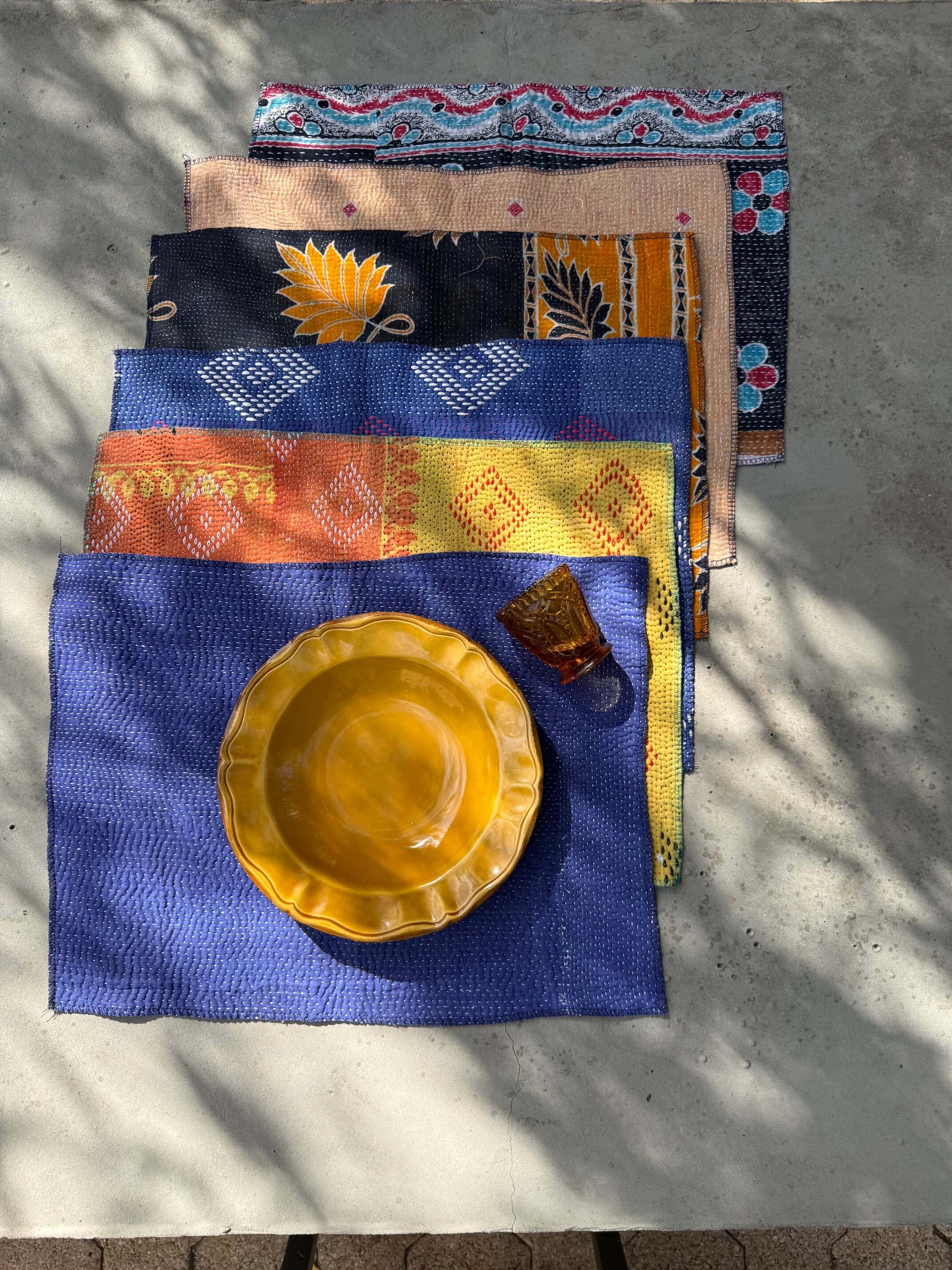Détail du tissu et des surpiqûres colorées d’un set de table Kantha
