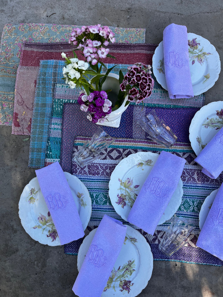Table vintage avec vaisselle ancienne fleurie, serviettes monogrammées lilas et sets de table kantha – Les Tables du Roi Arthur